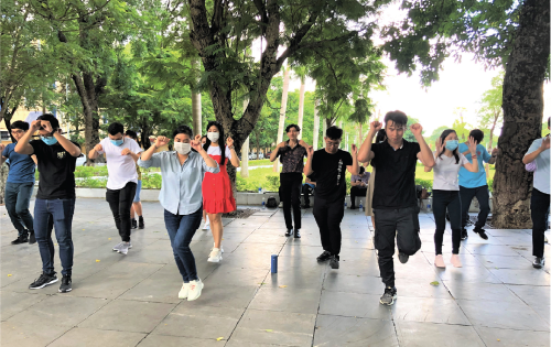 Performers practing the "Jealousy of CoVy" dance in the park.