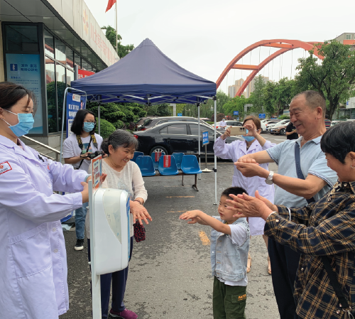 Patients and family members learning proper hand-rub methods from hospital staff